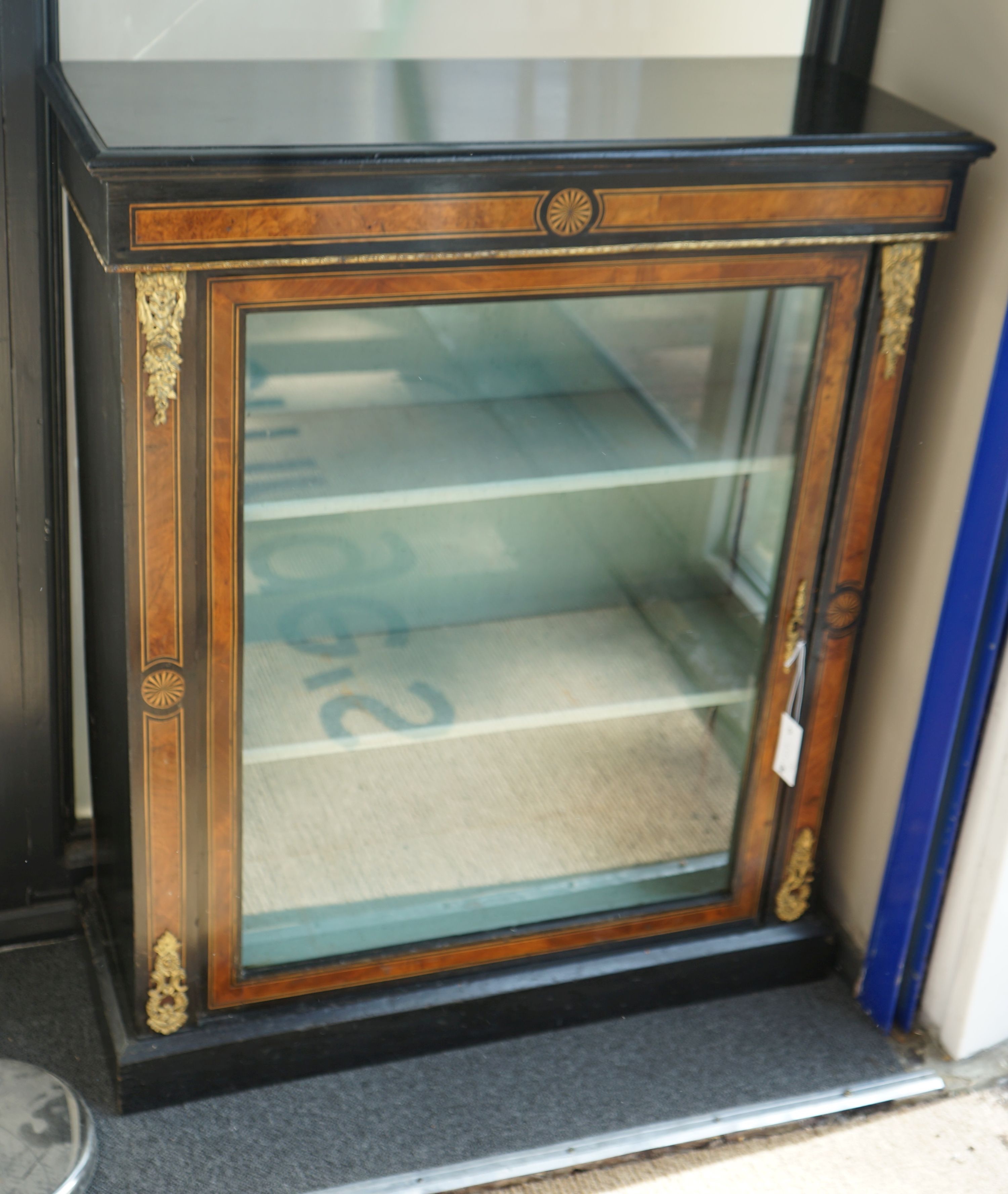 A pair of late Victorian ebonised amboyna banded pier cabinets, width 83cm, depth 32cm, height 100cm